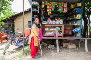 Gomati Bhandari stands in front of her shop in the Kachanpur district of Nepal.