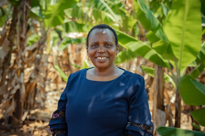 Honorable Chido Madiwa is smiling in front of leaves and trees behind her.