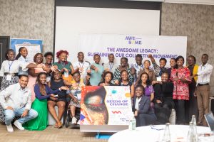 Members of the AWESOME Consortium are together with a big version of the front cover of the book at the launch event